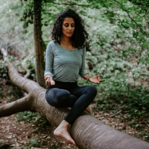 Shirani Rose beim Meditieren auf einem Baum